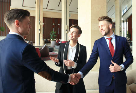 Business people shaking hands, finishing up a meeting.の写真素材