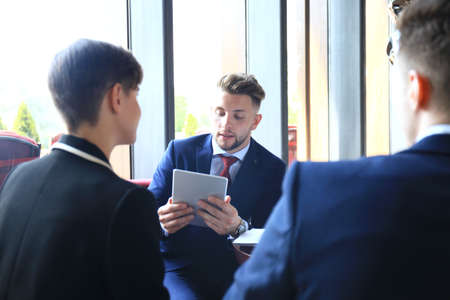 Happy smart business man with team mates discussing.の写真素材