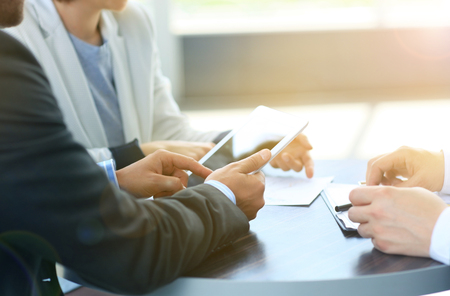 Businessman hands touching digital tablet empty screen copy space, handshake during meeting.の写真素材