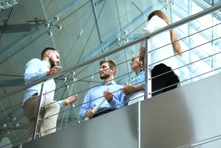 Bottom view. Modern people in casual wear having a brainstorm meeting while standing in the creative office.の写真素材