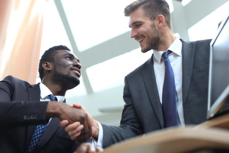 Business meeting. African American businessman shaking hands with caucasian businessman.の写真素材