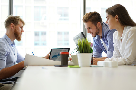 Business adviser analyzing financial figures denoting the progress in the work of the company.の写真素材