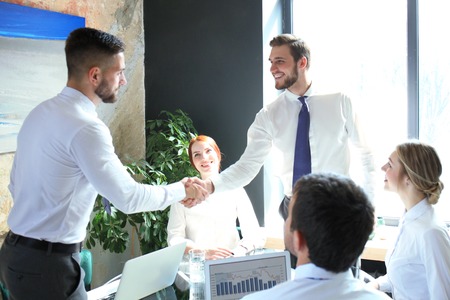 Business people shaking hands, finishing up a meeting