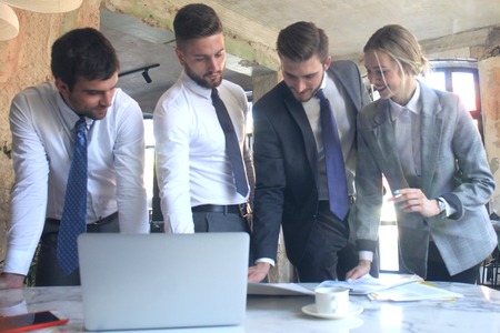 business team working on laptop to check the results of their work