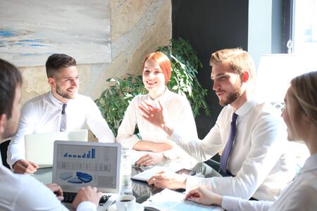 Group of business partners discussing ideas and planning work in officeの写真素材