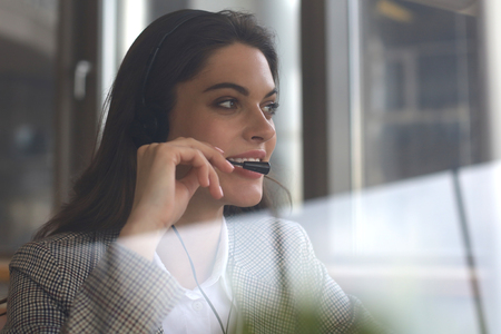 Woman customer support operator with headset and smilingの写真素材