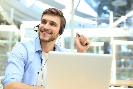 Smiling friendly handsome young male call centre operator