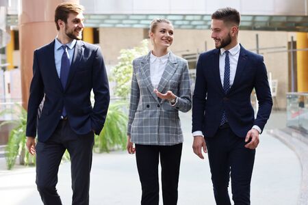 businesspeople group walking at modern bright office interior