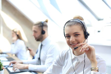 Female customer support operator with headset and smilingの写真素材