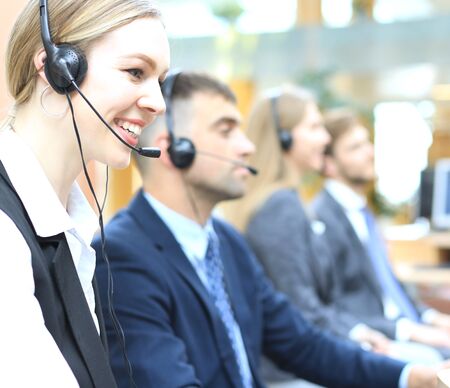 Female customer support operator with headset and smilingの写真素材