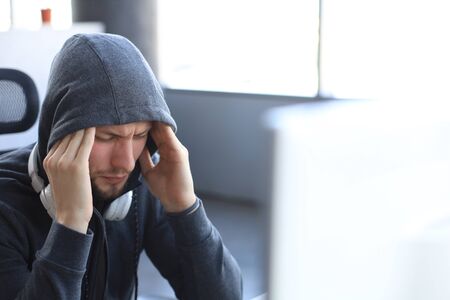 Young upset gamer playing online video games on computer and feel depressedの写真素材