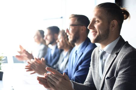 Photo of happy business people applauding at conference.の写真素材