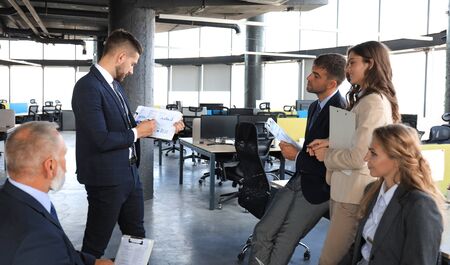 Business team discussing together business plans in office