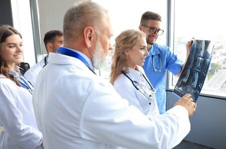 Group of doctors checking x-rays in a hospitalの写真素材