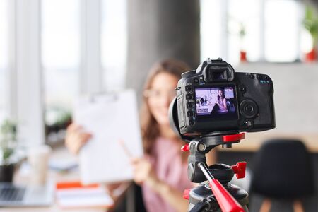 Beautiful young woman talking and smiling while making new video for her blog