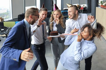 Happy birthday. Celebrating in office with colleguesの写真素材