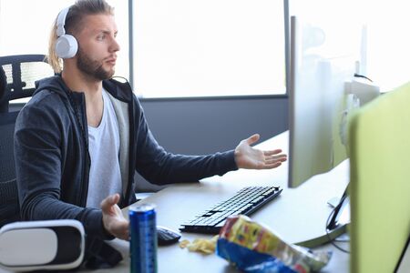 Young upset gamer playing online video games on computer and feel depressed.