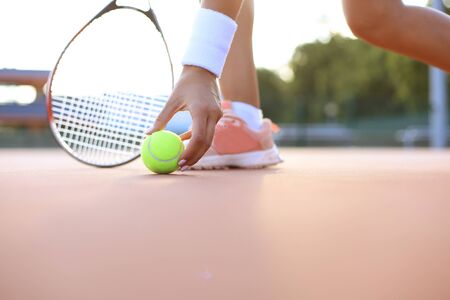 Tennis racket and the ball on tennis courtの写真素材