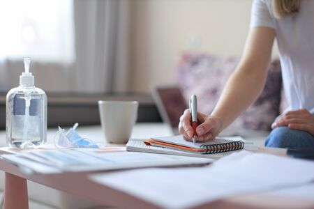 Young woman works from home during self isolation and quarantine. Work online and stay at home....
