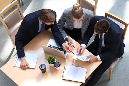 Top view of buiness team brainstorming while sitting at the office table togetherの写真素材