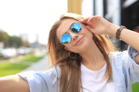 Trendy cool hipster girl drink cocktail in urban city backgroundの写真素材