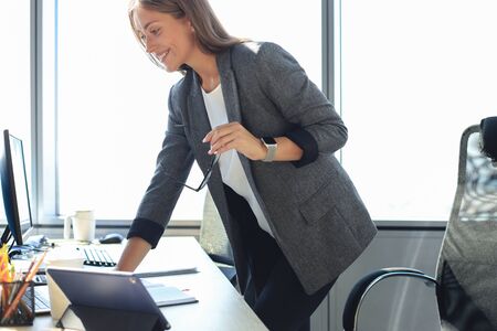 Beautiful business woman working on laptop in the office.