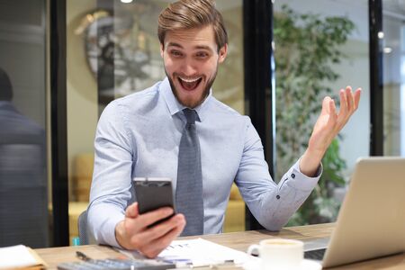 Businessman using his mobile phone in the office