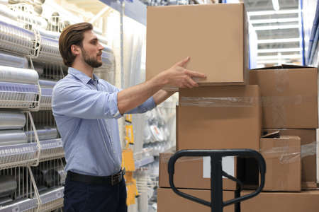 Portrait of a smiling warehouse keeper at workの写真素材