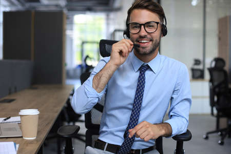 Smiling friendly handsome young male call center operator