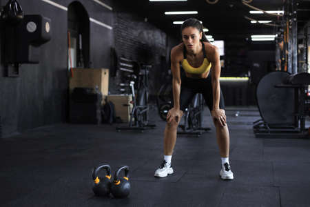 Sporty woman resting, having break after doing exercise