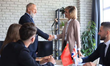 Diversity people talk the international conference partnership. Business people shaking hands, finishing up a meetingの写真素材