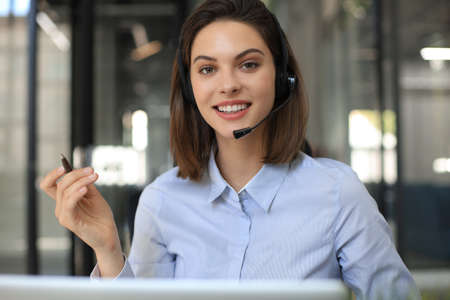 Woman customer support operator with headset and smilingの写真素材