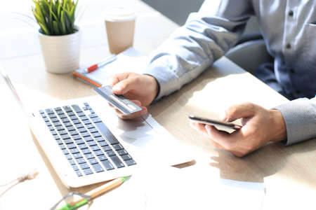 Mpderm man using credit card and mobile phone for online payment. Mobile shopping concept