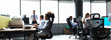 Young business people in formalwear are using modern technology while working in the office.の写真素材