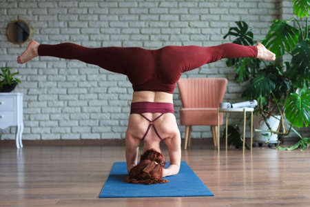 Sporty woman in sportswear practicing yoga, working out at home or in yoga studio