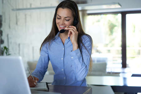 Female customer support operator with headset and smiling