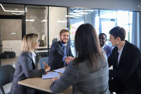Job applicant having interview. Handshake while job interviewingの写真素材