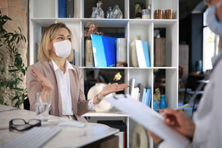 Psychologist listening to her patient and writing down notes. Mental health and counseling conceptの写真素材