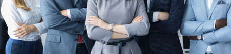 Cropped shot of a group of businesspeoplee standing together in office.の写真素材