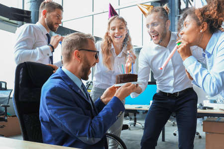 Business team celebrating a birthday of collegue in the modern office.の写真素材