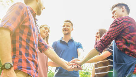 Friends join hand together during at barbecue in nature.の写真素材