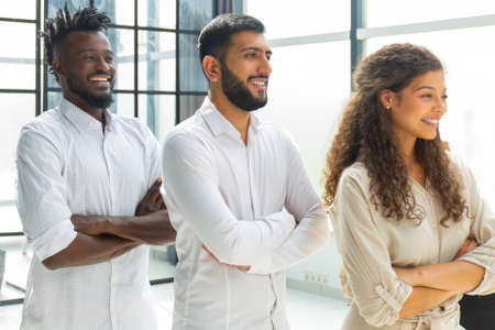 Group of confident young people standing in a conference room