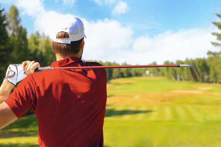 Athletic young man playing golf in golfclubの写真素材