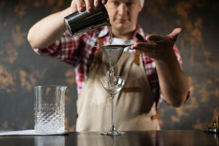 Barman at work, preparing cocktails. concept about service and beverages