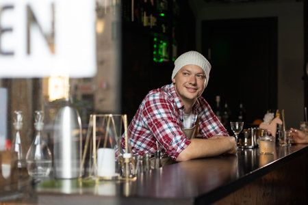 cafe owner. Pleasant delighted man sitting near the counter, smilingの写真素材