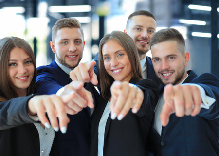 Portrait of call center worker accompanied by his team. Smiling customer support operator at work.の写真素材