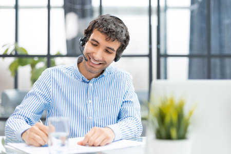 Smiling friendly handsome young male call centre operator