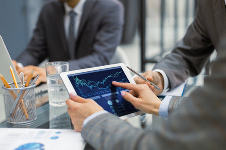 Business adviser analyzing financial figures denoting the progress in the work of the companyの写真素材