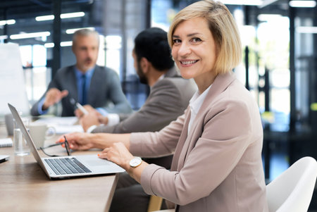 Face of beautiful middle aged woman on the background of business people