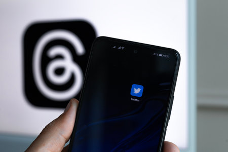MINSK, BELARUS - July 07, 2023: Twitter app logo on smartphone screen. Against the background of the new competitive application Threads from Meta Platformsのeditorial素材